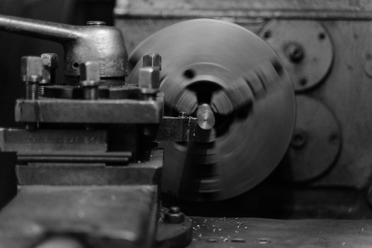 Crafting Captivating Headlines: Your awesome post title goes here Black and white close-up of an industrial lathe machine showing its intricate mechanical details.
