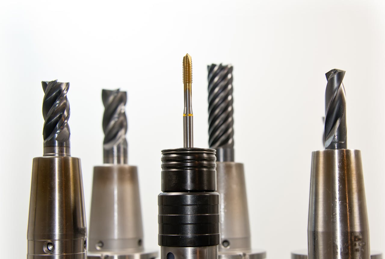 A close-up view of metal drill bits arranged vertically, showcasing industrial tools.